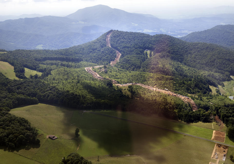 FILE - Cahas Mountain looms over the path of the Mountian Valley Pipeline as it crosses the Blue Ridge Parkway at Adney Gap on July 18, 2018. The Supreme Court is allowing construction to resume on a contested natural-gas pipeline that is being built through Virginia and West Virginia. Work had been halted by the federal appeals court in Richmond, even after Congress ordered the project's approval as part of the bipartisan bill to increase the debt ceiling. President Joe Biden signed the bill into law in June. (Heather Rousseau/The Roanoke Times via AP)