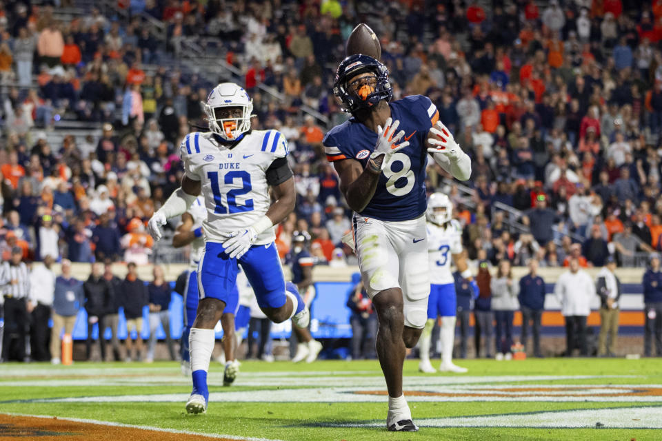 Virginia wide receiver Malachi Fields (8) drops a pass as he is defended by Duke linebacker Tre Freeman (12) during the second half of an NCAA college football game Saturday, Nov. 18, 2023, in Charlottesville, Va. (AP Photo/Mike Caudill)