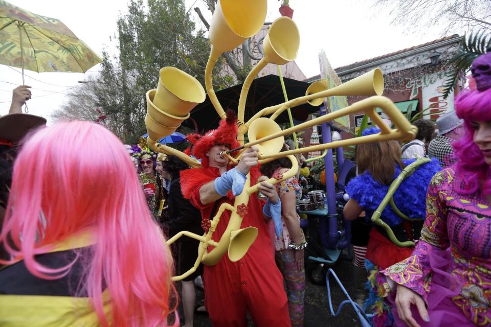 Revelers gather for the start of the Society of Saint Anne walking parade in the Bywater section of New Orleans during Mardi Gras day, Tuesday, Feb. 12, 2013. Overcast skies and the threat of rain couldn't dampen the revelry of Mardi Gras as parades took to the streets, showering costumed merrymakers with trinkets of all kinds. (AP Photo/Gerald Herbert)