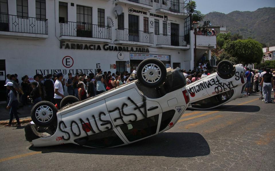 Protesters used overturned cars to block streets after the killing of the child
