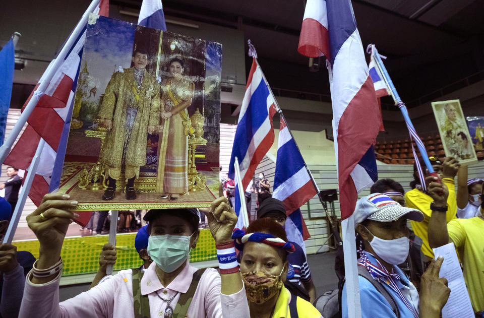 Supporters of the Thai monarchy hold up images of King Maha Vajiralongkorn and Queen Suthida during a rally in Bangkok, Thailand, Sunday Aug. 30, 2020. A two-day rally planned for this weekend is jangling nerves in Bangkok, with apprehension about how far student demonstrators will go in pushing demands for reform of Thailand’s monarchy and how the authorities might react. More than 10,000 people are expected to attend the Saturday-Sunday event. (AP Photo/Sakchai Lalit)