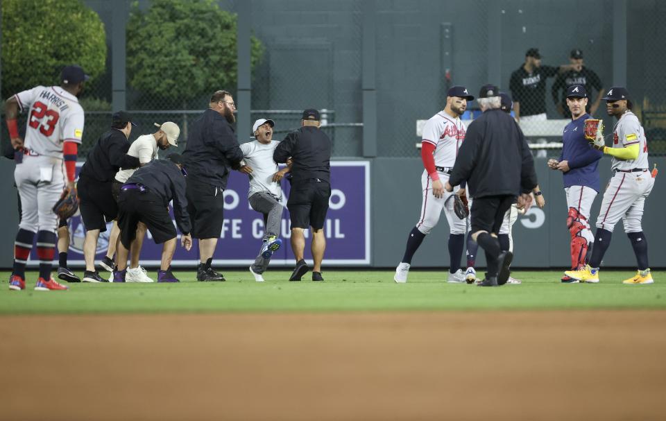 DENVER, COLORADO - AUGUST 28: A fan yells to Ronald Acuna Jr. #13 of the Atlanta Braves after running on the field and being apprehended by security during the game between the Colorado Rockies and the Atlanta Braves at Coors Field on August 28, 2023 in Denver, Colorado. (Photo by Tyler Schank/Clarkson Creative/Getty Images)