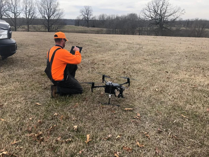 Luke Miller prepares to fly a drone.