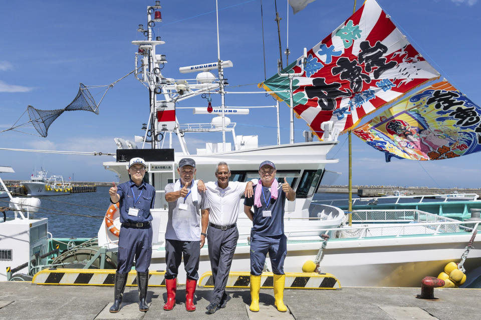 In this photo provided by U.S. Embassy, U.S. Ambassador to Japan Rahm Emanuel, center right, poses with local fishermen at a port in Soma city, Fukushima prefecture, Thursday, Aug. 31, 2023. U.S. Ambassador Emanuel visited a northern Fukushima city Thursday and had seafood lunch with the mayor, talked to fishermen and stocked up on local produce at a grocery store to show they're all safe after the release of treated radioactive wastewater from the wrecked Fukushima Daiichi plant to the sea, backing Japan effort while criticizing China's ban on Japanese seafood as political.(U.S. Embassy via AP)