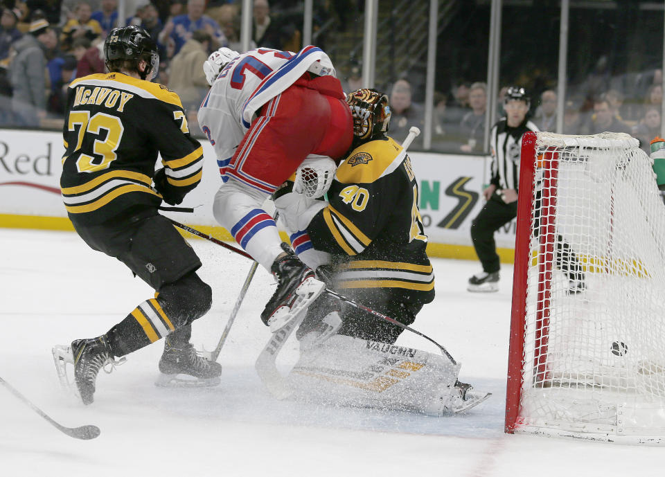 FILE - In this Jan. 19, 2019, file photo, New York Rangers center Filip Chytil (72) collides with Boston Bruins goaltender Tuukka Rask (40) as he scores a goal during the first period of an NHL hockey game in Boston. The goal counted, Chytil faced no repercussions and Rask was concussed. Those kinds of collisions are happening at an alarming rate over the past couple of seasons, leading to an increase in goaltender concussions. (AP Photo/Mary Schwalm, File)