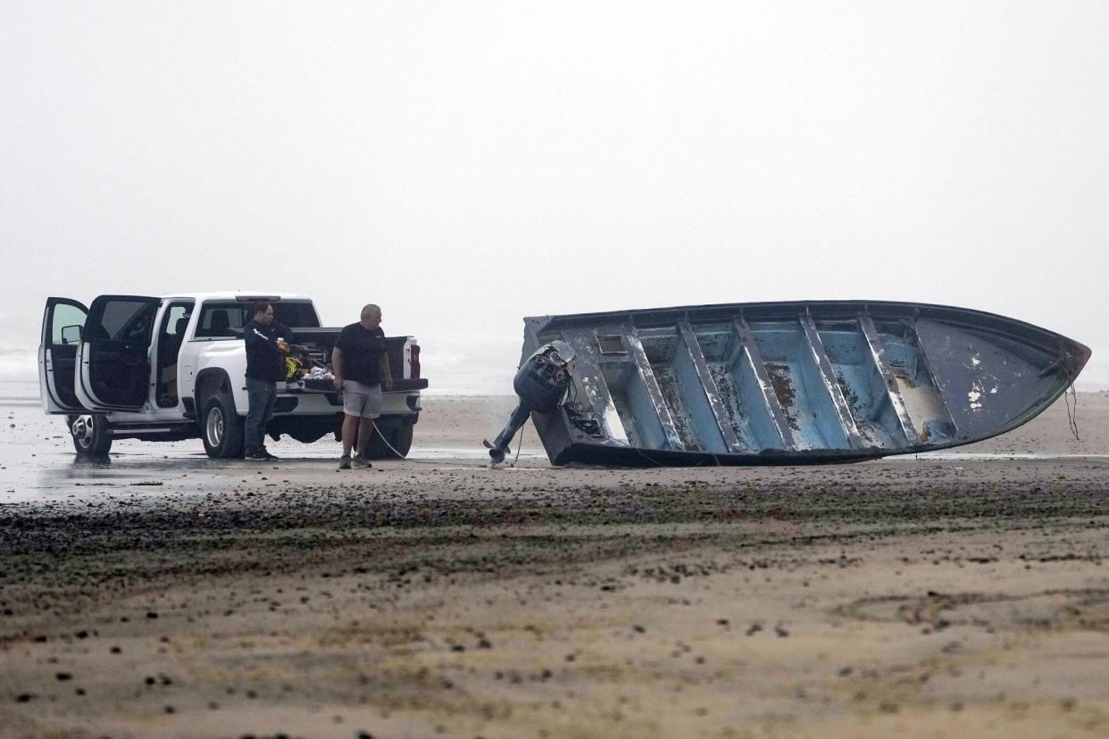 Boat salvager Robert Butler, right, and KC Ivers, left, prepare to move one of two boats on Blacks Beach, in San Diego. Authorities say multiple people were killed when two suspected smuggling boats overturned off the coast of San Diego, and crews were searching for additional victims California Boat Deaths, San Diego, United States - 12 Mar 2023