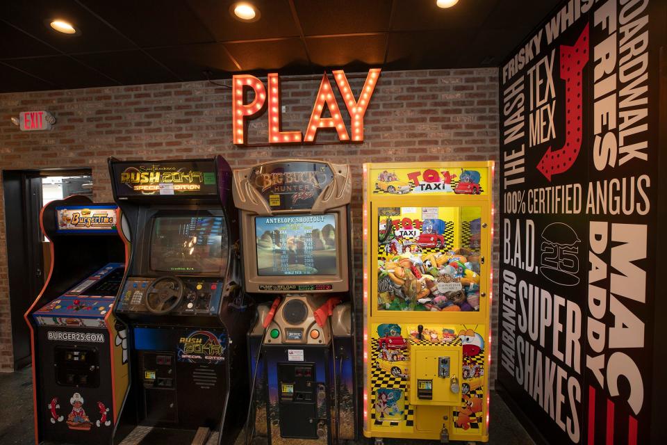 Arcade games in the dining room of Burger 25, known for its burgers of the month and hand-spun milkshakes.