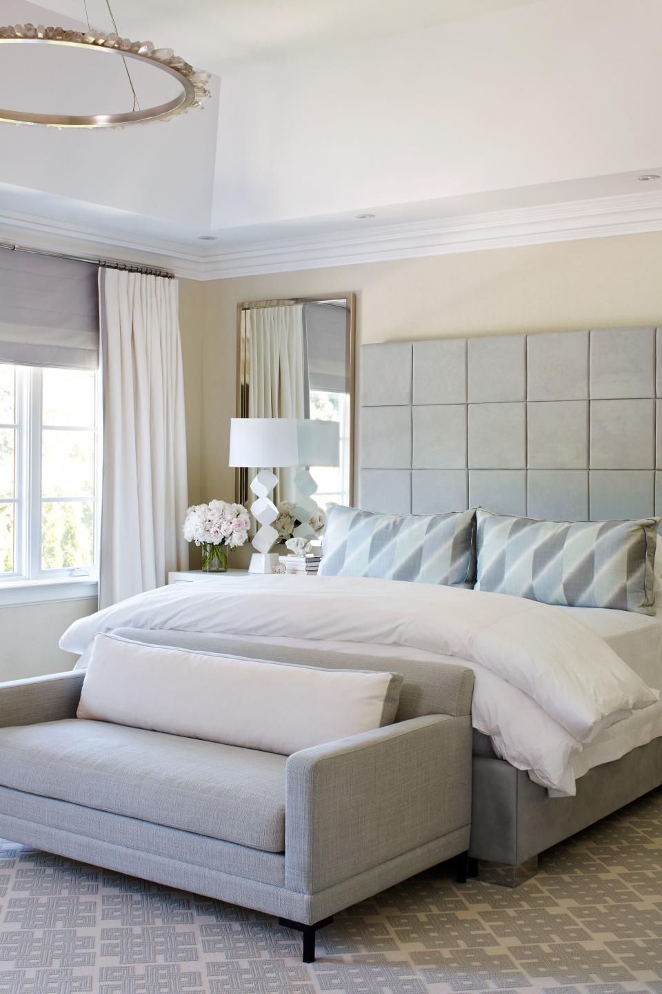 Hepfer went with a geometric Ultrasuede headboard in the master bedroom. Overhead is a rock crystal chandelier by Christopher Boots.