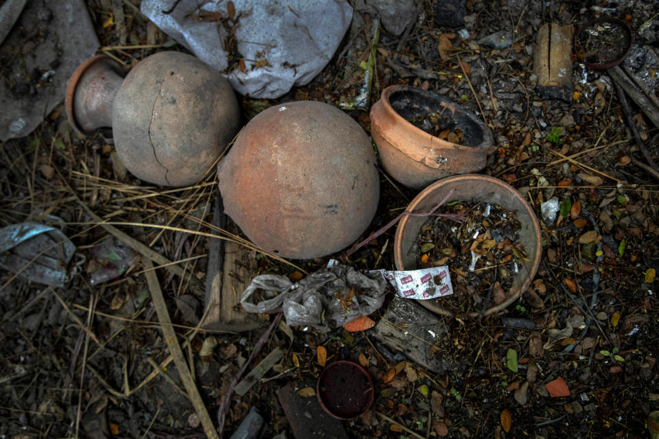 Earthen pots used during the cremation of a deceased COVID-19 victim lie in a cremation ground in Gauhati, India, Friday, July 2, 2021. The personal belongings of cremated COVID-19 victims lie strewn around the grounds of the Ulubari cremation ground in Gauhati, the biggest city in India’s remote northeast. It's a fundamental change from the rites and traditions that surround death in the Hindu religion. And, perhaps, also reflects the grim fears grieving people shaken by the deaths of their loved ones — have of the virus in India, where more than 405,000 people have died. (AP Photo/Anupam Nath)