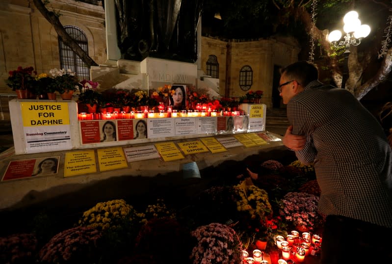 FILE PHOTO: Tourist looks at makeshift memorial to assassinated anti-corruption journalist Caruana Galizia after an anti-corruption protest against the government of Prime Minister Muscat in Valletta