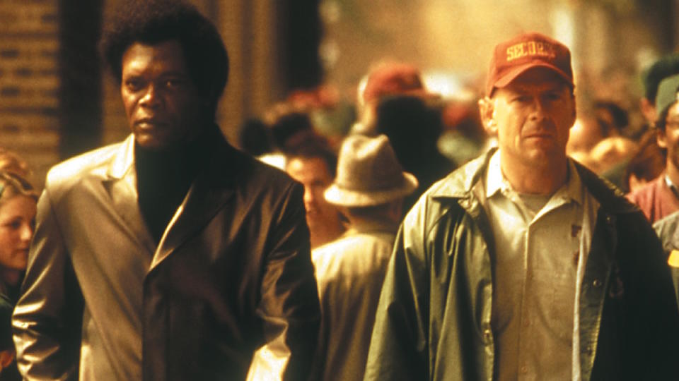 Samuel L. Jackson and Bruce Willis walk around a sports stadium in Unbreakable