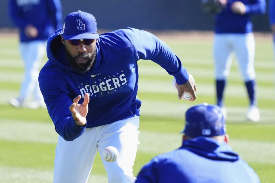 Dodgers outfielder Jason Heyward reaches for the ball during outfielder practice February 16, 2023.