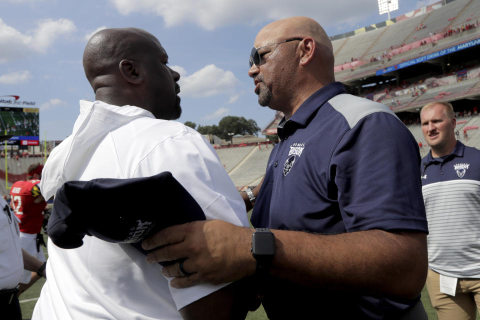 Maryland head coach Michael Locksley, left, shakes hands with Howard head coach Ron Prince after an NCAA college football game, Saturday, Aug. 31, 2019, in College Park, Md. Maryland won 79-0. (AP Photo/Julio Cortez)