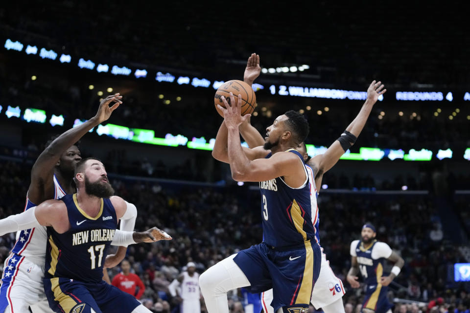 New Orleans Pelicans guard CJ McCollum (3) drives to the basket as center Jonas Valanciunas (17) blocks out Philadelphia 76ers center Mo Bamba in the first half of an NBA basketball game against the Philadelphia 76ers in New Orleans, Wednesday, Nov. 29, 2023. (AP Photo/Gerald Herbert)