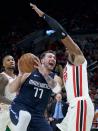 Dallas Mavericks guard Luka Doncic (77) drives to the basket past Portland Trail Blazers center Hassan Whiteside during the first half of an NBA basketball game in Portland, Ore., Thursday, Jan. 23, 2020. (AP Photo/Craig Mitchelldyer)