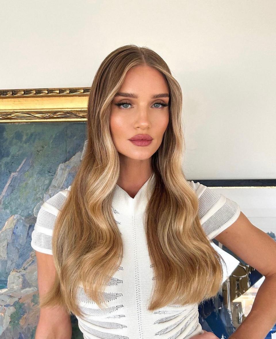 Go full glam with shiny and long waves. "Waterfall waves scream luxury and are great for long hair wearers who want a glamorous and polished vibe," says Wood. “It’s all about shiny, frizz-free polished waves for this look." Protect strands from cold weather to keep hair in top shape. “A good <a href="https://www.glamour.com/gallery/best-hair-masks-for-dry-damaged-hair?mbid=synd_yahoo_rss" rel="nofollow noopener" target="_blank" data-ylk="slk:hair mask;elm:context_link;itc:0" class="link ">hair mask</a> before styling to add shine and softness is a must-have. Use plenty of shine spry and a good brush like a <a href="https://www.dermstore.com/mason-pearson-pocket-mixture-boar-bristle-and-nylon-hairbrush/11288625.html" rel="nofollow noopener" target="_blank" data-ylk="slk:Mason Pearson;elm:context_link;itc:0" class="link ">Mason Pearson</a> for brushing out the waves to achieve a glossy almost water-like effect,” he adds.