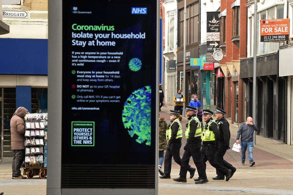 A group of police officers patrol Briggate in central Leeds on the morning of March 21, 2020, a day after the British government said it would help cover the wages of people hit by the coronavirus outbreak as it tightened restrictions to curb the spread of the disease. (Photo by Oli SCARFF / AFP) (Photo by OLI SCARFF/AFP via Getty Images)