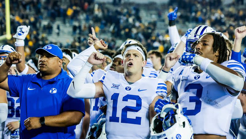 BYU QB Jake Retzlaff (No. 12) joins teammates and coaches in singing the school fight song following the Cougars’ 37-7 loss. 