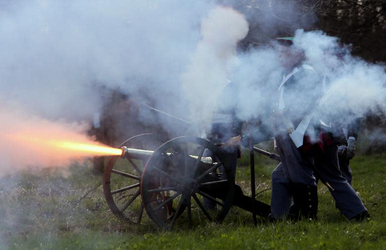 Re-enactors dressed as French troops take part in a trial re-enactment of the Battle of Waterloo in the grounds of Ickworth House near Bury St Edmunds, east England, on April 11, 2015