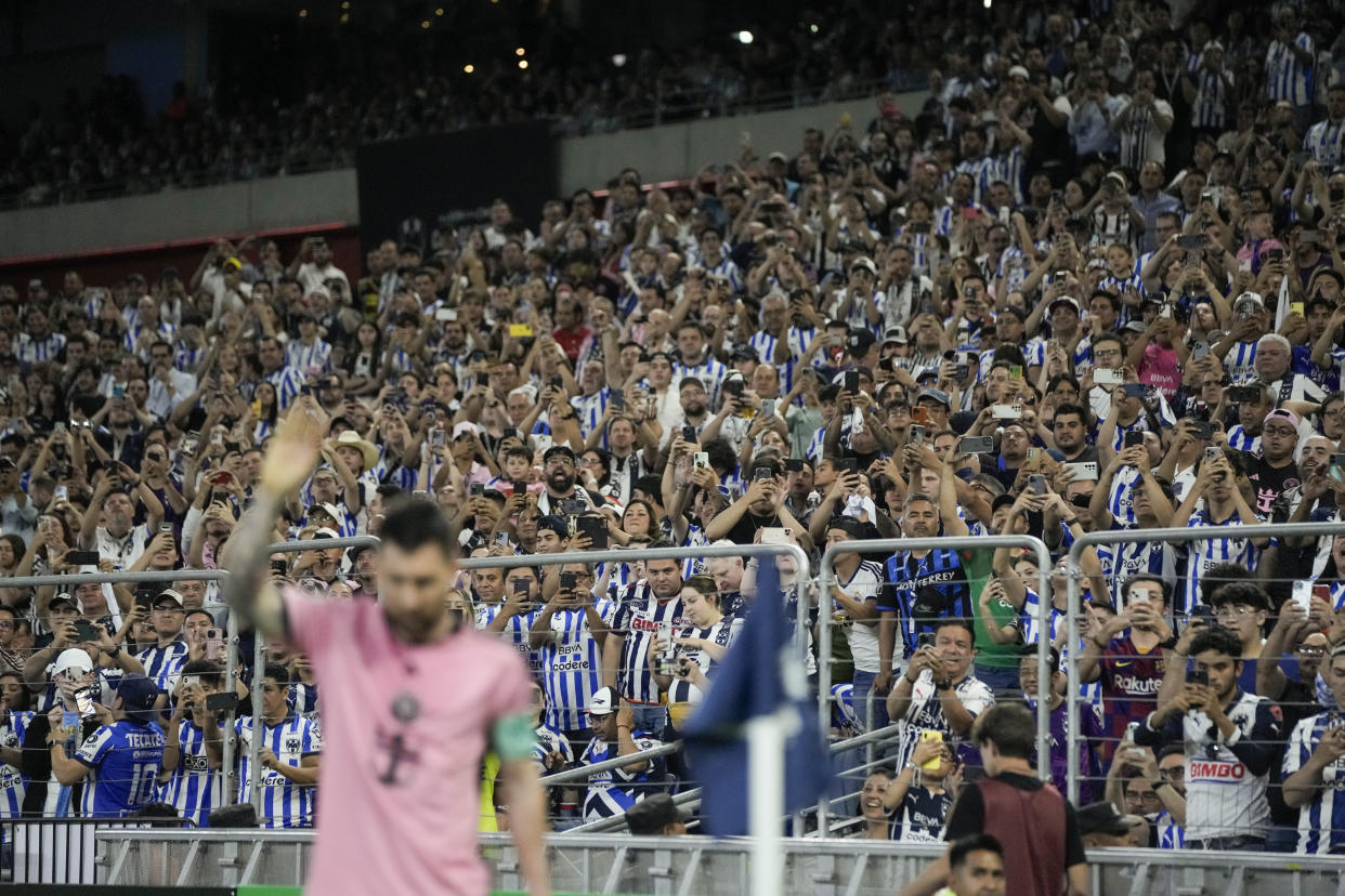 Fans use their mobile phones to take photos as Inter Miami's Lionel Messi takes a corner kick during a CONCACAF Champions Cup quarter final second leg soccer match against Monterrey at the BBVA stadium in Monterrey, Mexico, Wednesday, April 10, 2024. (AP Photo/Eduardo Verdugo)