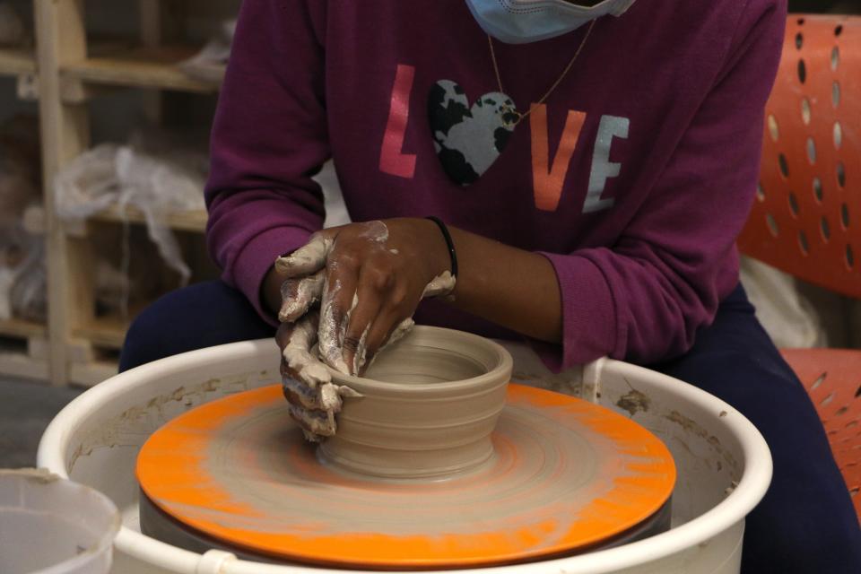 Student in Buchanan Arts Young Artists after school program in 2022-2023 school year practices wheel throwing pottery.