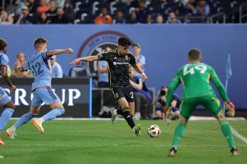 Jun 14, 2024; Bronx, New York, USA; Columbus Crew forward Max Arfsten (27) plays the ball against New York City FC defender Strahinja Tanasijevic (12) and goalkeeper Matt Freese (49) during the second half at Yankee Stadium. Mandatory Credit: Brad Penner-USA TODAY Sports