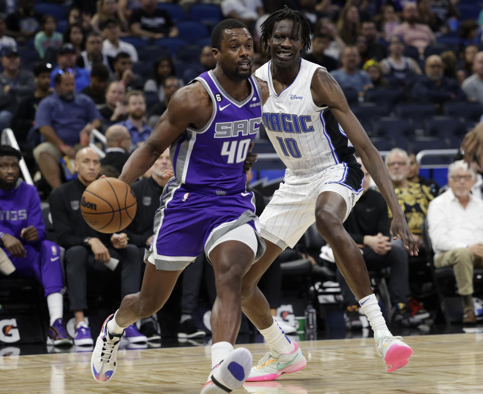 Sacramento Kings forward Harrison Barnes (40) makes a move around Orlando Magic center Bol Bol (10) during the first half of an NBA basketball game, Saturday, Nov. 5, 2022, in Orlando, Fla. (AP Photo/Kevin Kolczynski)