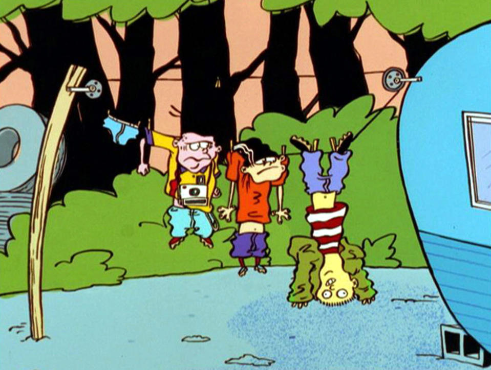 Ed, Edd and Eddy hang from a clothesline outside of a trailer, Ed hangs upside down by his feet while Double D and Eddy are pinned by their sleeves.