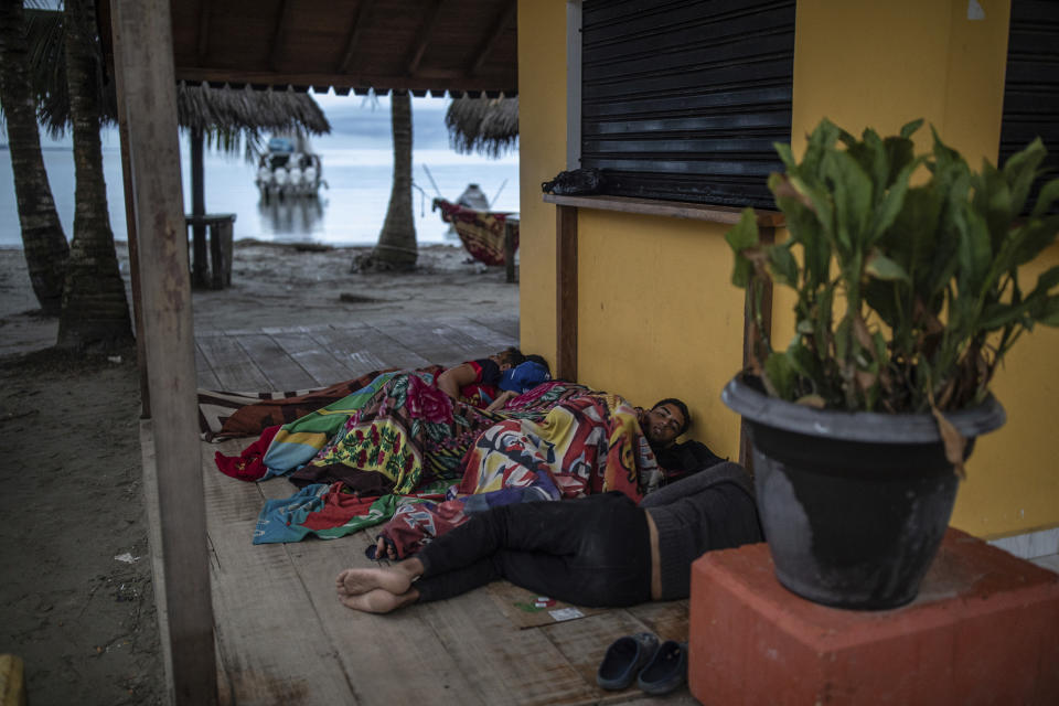 Migrants sleep on the beach, in Necocli, Colombia, Saturday, Oct. 7, 2023. New York City Mayor Eric Adams has capped off a four-day trip to Latin America with a visit to the northern Colombian city where thousands of migrants start the perilous trek across the Darien jungle, as they head to the United States. (AP Photo/Ivan Valencia)