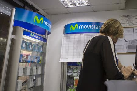 A customer is attended to at a Movistar Service Center in Caracas, Venezuela September 15, 2015. REUTERS/Marco Bello