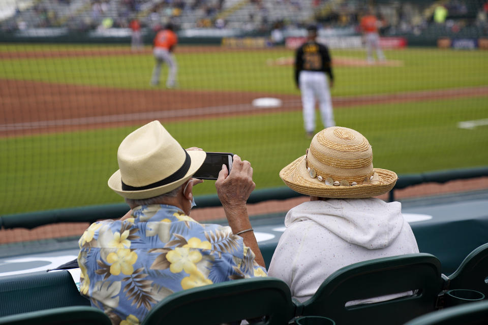 FILE - In this Monday, March 22, 2021 file photo, two older adults socially distanced, watch a spring training exhibition baseball game between the Pittsburgh Pirates and the Baltimore Orioles in Bradenton, Fla. Spring has arrived with sunshine and warmer temperatures, and many vaccinated seniors are emerging from COVID-19-imposed hibernation. (AP Photo/Gene J. Puskar, File)