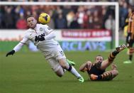 Manchester United's Wayne Rooney (L) is challenged by Hull City's David Meyler during their English Premier League soccer match at the KC Stadium in Hull, northern England December 26, 2013. REUTERS/Nigel Roddis