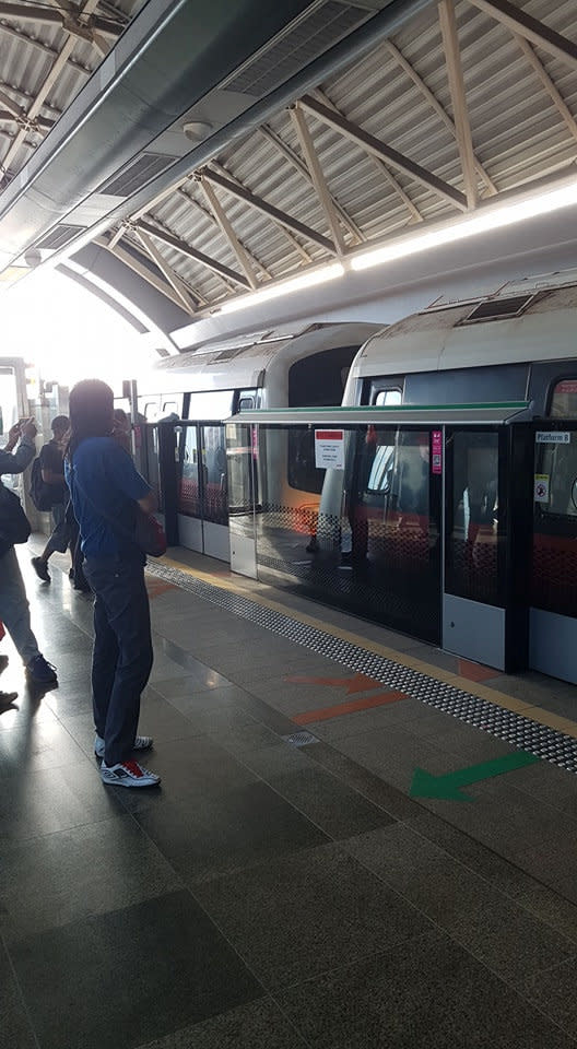 People look after a mass transit train collision at a platform at Joo Koon station in Singapore