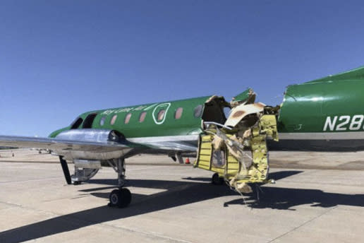 This image from CBS Denver shows a Key Lime Air Metroliner that landed safely at Centennial Airport after a mid-air collision near Denver on Wednesday, May 12, 2021. Federal officials say two airplanes collided but that there are no injuries. The collision between a twin-engine Fairchild Metroliner and a single-engine Cirrus SR22 happened as both planes were landing, according to the National Transportation Safety Board. Key Lime Air, which owns the Metroliner, says its aircraft sustained substantial damage to the tail section but that the pilot was able to land safely. (CBS Denver via AP)