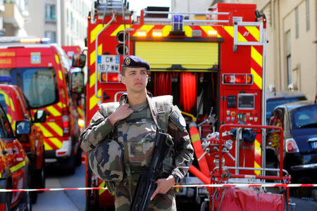 French firefighters and soldiers secure the street as police conduct an investigation after two Frenchmen were arrested in Marseille, France, April 18, 2017 for planning to carry out an "imminent and violent attack" ahead of the first round of the presidential election on Sunday, France's interior minister said. REUTERS/Philippe Laurenson 