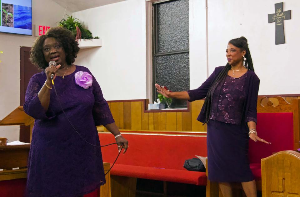Deaconess Floretha Bryant ,left, assists the Pilgrim Rest COGIU Praise Ensemble in leading praise and worship while Pastor Gwendolyn Williams, right, dances along at the church in northeast Gainesville on Sunday during a service celebrating the second anniversary of Williams as pastor of the church.