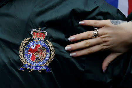 A woman's hand and the logo of Britain First are pictured during a rally in Rochester, Britain November 15, 2014. Picture taken November 15, 2014. REUTERS/Kevin Coombs