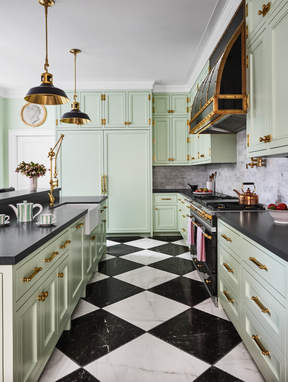 a kitchen with black and white tiles