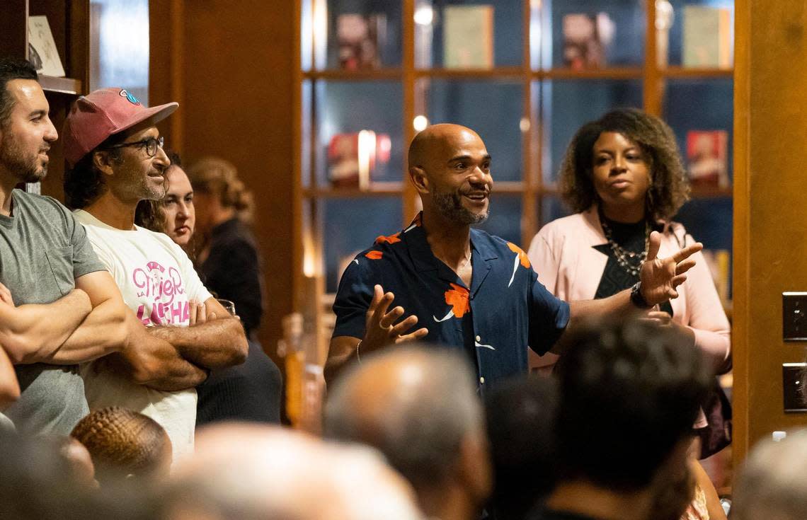 Damian Fyffe, 43, center, asks his cousin Jonathan Escoffery a question during a book reading at Books & Books. Escoffery’s family still lives in Miami.