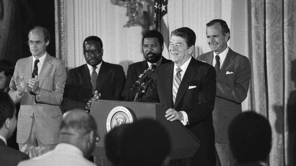 Clarence Thomas, second from left, stands with President Reagan as the President addressed black appointees at the White House in 1984. - Bettmann Archive/Getty Images