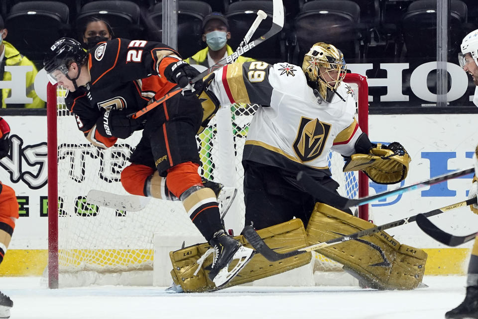 Anaheim Ducks' Sam Steel (23) collides with Vegas Golden Knights goaltender Marc-Andre Fleury (29) during the third period of an NHL hockey game Sunday, April 18, 2021, in Anaheim, Calif. (AP Photo/Marcio Jose Sanchez)