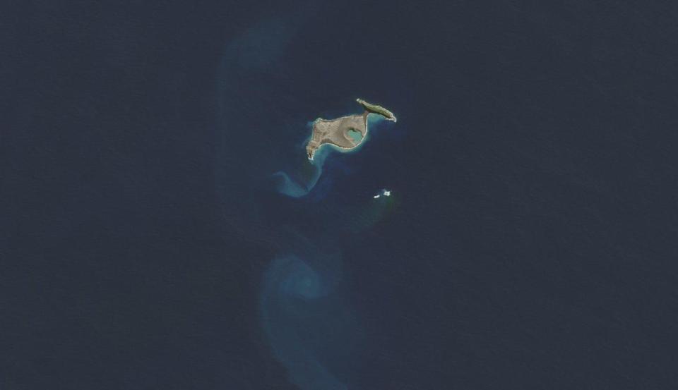 This satellite image shows an intact Hunga Tonga-Hunga Ha'apai in April 2015, years before an explosive underwater volcanic eruption obliterated most of the Polynesian island in January 2022. / Credit: NASA Earth Observatory image by Jesse Allen, using Landsat data from the U.S. Geological Survey