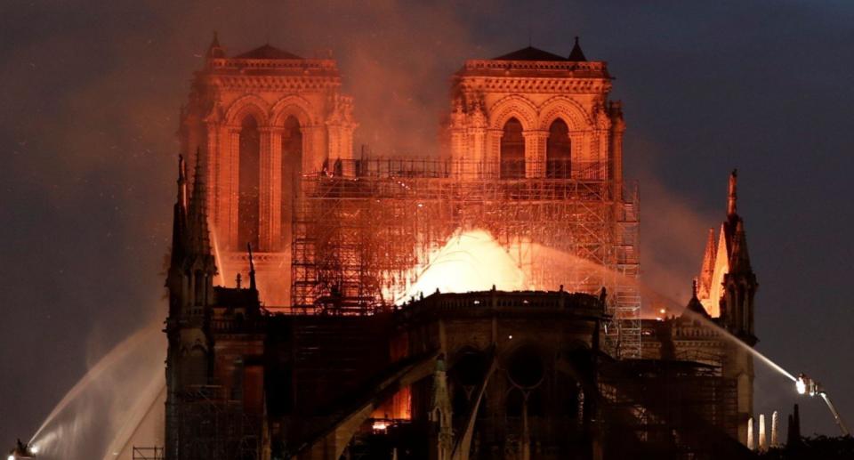 Firefighters douse flames from the burning Notre Dame Cathedral in Paris (Reuters)