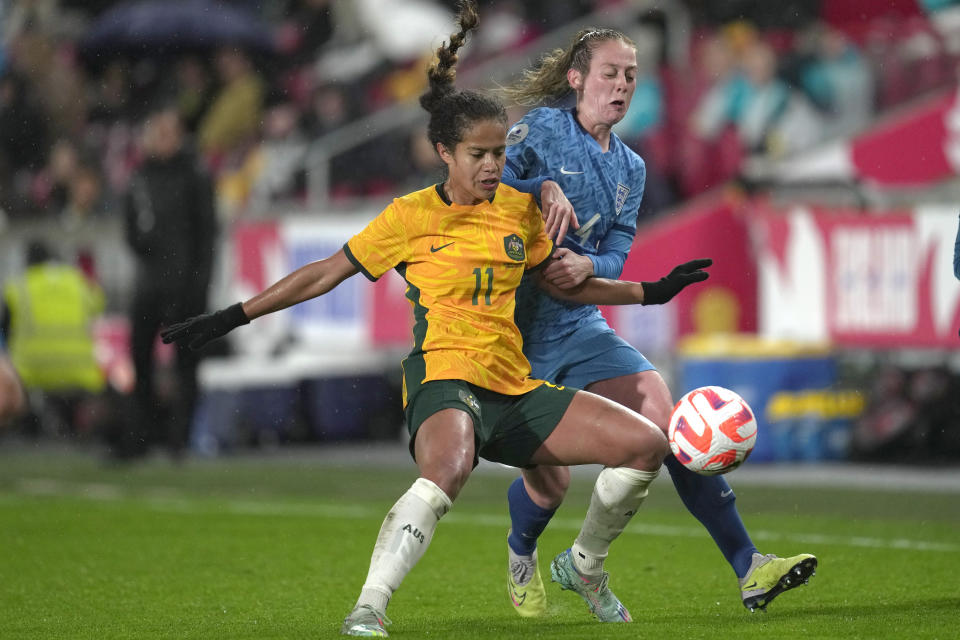 England's Keira Walsh, right, and Australia's Mary Fowler fight for the ball during the women's international friendly soccer match between England and Australia at the Gtech Community Stadium in London, England, Tuesday, April 11, 2023. (AP Photo/Kin Cheung)