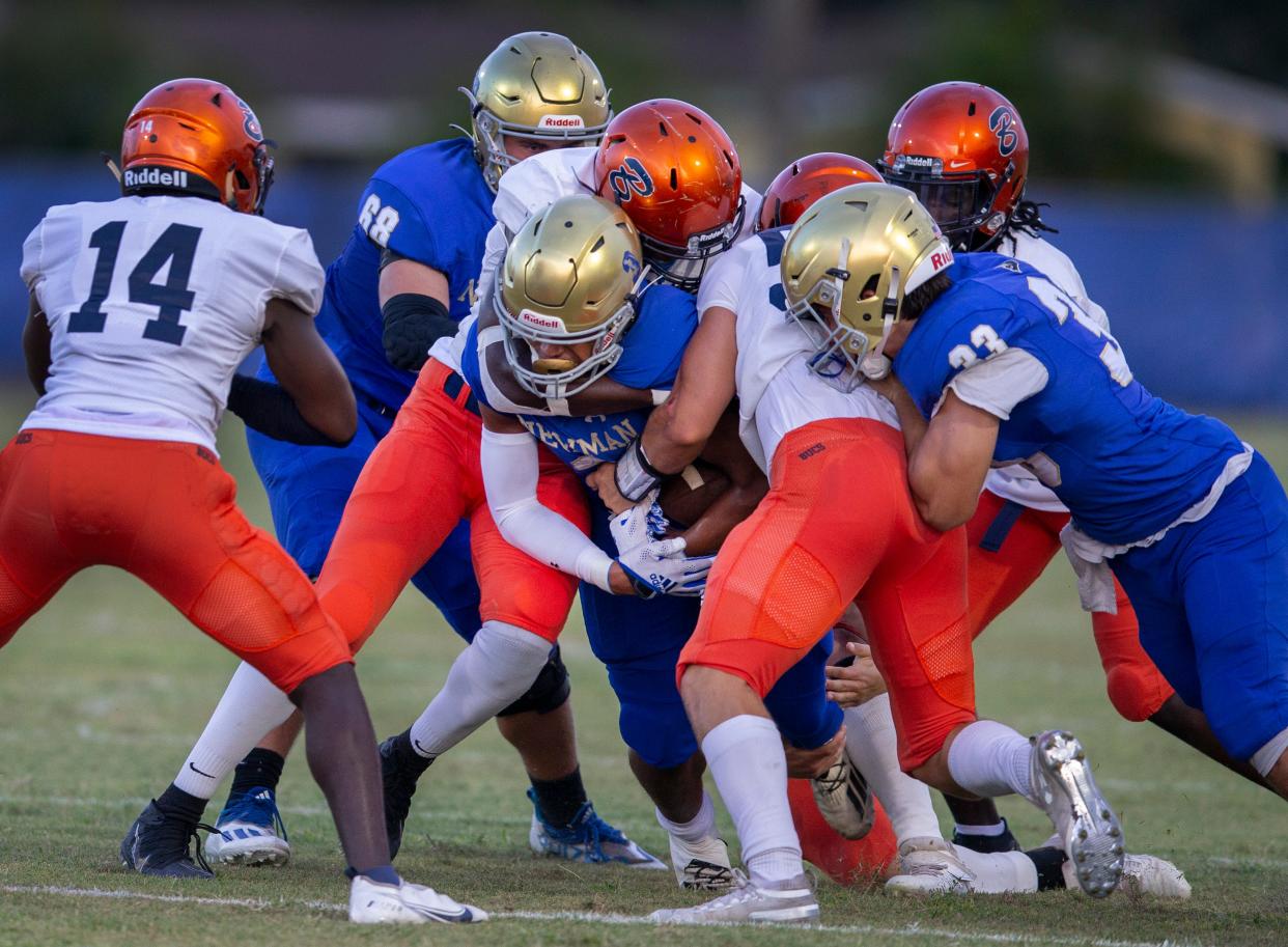 Cardinal Newman running back Tovani Mizell is stopped by the Benjamin defense during their game in West Palm Beach, Florida, on Sept. 10, 2021. Mizell committed to UK in June.