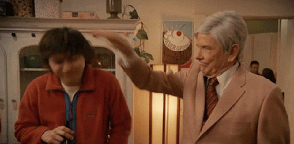 a johnny carson impersonator hits a young boy across the head