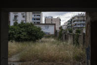 In this Sunday, May 31, 2020 photo the painted-over screen of the Myrto open-air cinema, abandoned since 1987, is seen in Athens. Thirty years ago, there were roughly 600 such cinemas all over Greece. Social change and technological advance has resulted in just over a hundred currently functioning, several of them protected by heritage laws. (AP Photo/Petros Giannakouris)