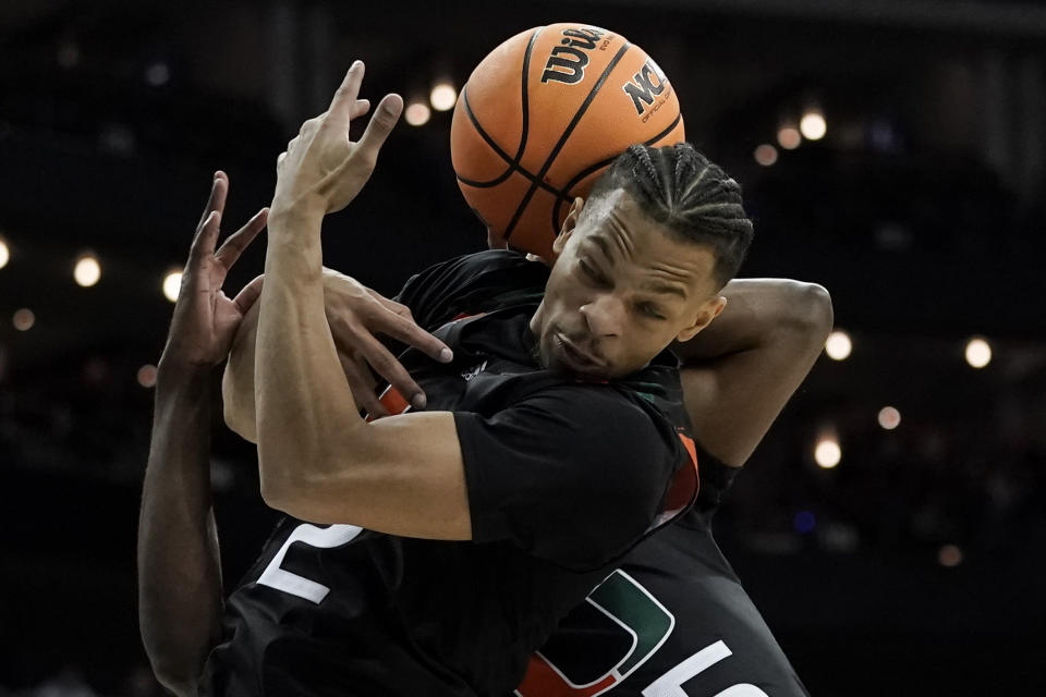 Miami guard Isaiah Wong tries for a rebound against Houston in the first half of a Sweet 16 college basketball game in the Midwest Regional of the NCAA Tournament Friday, March 24, 2023, in Kansas City, Mo. (AP Photo/Charlie Riedel)