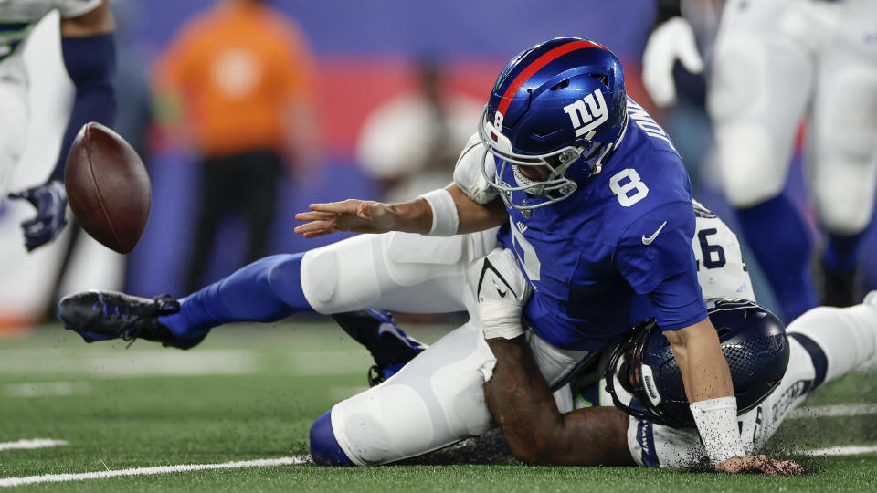 New York Giants quarterback Daniel Jones (8) fumbles the ball as he is tackled by Seattle Seahawks defensive end Mario Edwards Jr. (97). (AP Photo/Adam Hunger)