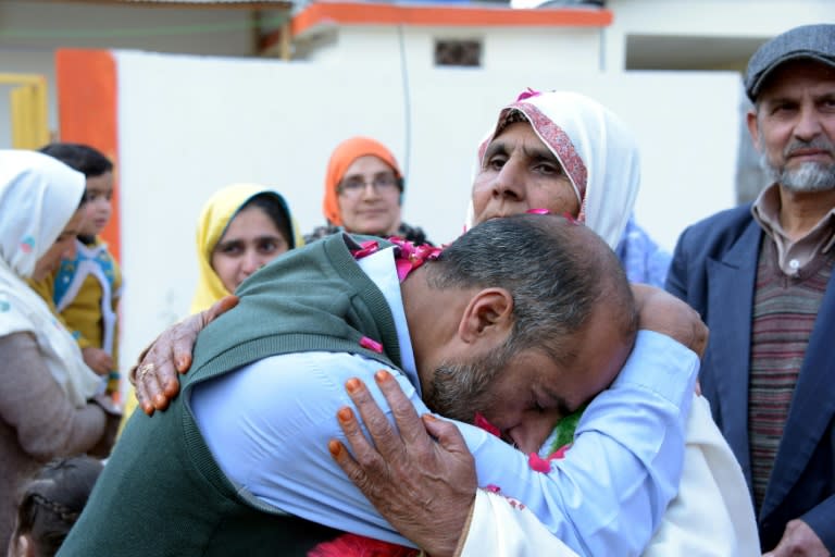 Indian mother Ashraf Jan holds her son for the first time in more than a quarter of a century, their families were among thousands torn apart by conflict in disputed Kashmir